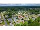 Aerial view showcases the neighborhood layout with its mature trees, and proximity to green spaces at 434 Deer Path, Calabash, NC 28467