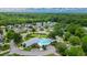 Aerial view shows an attractive neighborhood featuring a community pool and surrounding lush greenery at 434 Deer Path, Calabash, NC 28467