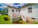 Exterior side-view of a white home with a quaint porch and a small set of stairs at 434 Deer Path, Calabash, NC 28467