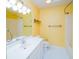 Bathroom featuring a vanity and bath with yellow walls at 434 Deer Path, Calabash, NC 28467