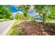 The community sign 'Saltaire Village' is surrounded by green foliage, flowers, and a picturesque neighborhood entrance at 434 Deer Path, Calabash, NC 28467