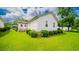 The home's exterior has a well-manicured lawn and trimmed shrubbery adding to its curb appeal at 434 Deer Path, Calabash, NC 28467