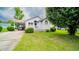 Charming home features a manicured lawn and attached carport at 434 Deer Path, Calabash, NC 28467