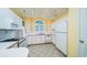 Bright kitchen features white appliances, pink trim, and an arched window at 434 Deer Path, Calabash, NC 28467