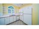 Bright kitchen featuring white appliances, pink trim, and a window view at 434 Deer Path, Calabash, NC 28467