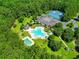 Aerial view of community featuring pools, tennis courts, and lush greenery at 45 Pinehurst Ln. # 2C, Pawleys Island, SC 29585