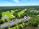Beautiful aerial view of the golf course community with lush greenery, parking, and ponds at 45 Pinehurst Ln. # 2C, Pawleys Island, SC 29585