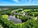 Aerial view of community with golf course, lakes, and multiple homes at 45 Pinehurst Ln. # 2C, Pawleys Island, SC 29585