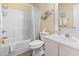 Bright bathroom features a shower/tub combo, decorative mermaid, and white cabinets at 45 Pinehurst Ln. # 2C, Pawleys Island, SC 29585