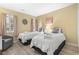 Cozy bedroom featuring two twin beds, decorative pillows, and a relaxing armchair at 45 Pinehurst Ln. # 2C, Pawleys Island, SC 29585