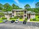 Beautiful condo complex featuring multiple stories, manicured landscaping, and ample parking at 45 Pinehurst Ln. # 2C, Pawleys Island, SC 29585