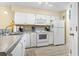 Bright kitchen featuring white appliances and ample cabinet space at 45 Pinehurst Ln. # 2C, Pawleys Island, SC 29585