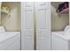 Laundry room features a washer, a dryer, and shelves at 45 Pinehurst Ln. # 2C, Pawleys Island, SC 29585