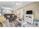 Cozy living room with plush furniture, ceiling fan, and access to other rooms at 45 Pinehurst Ln. # 2C, Pawleys Island, SC 29585
