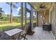 Relaxing screened-in porch overlooking a serene lake, with comfortable seating and outdoor furniture at 45 Pinehurst Ln. # 2C, Pawleys Island, SC 29585