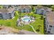 Aerial view showcases a pool and grassy common area nestled between well-maintained condo buildings at 4687 Wild Iris Dr. # 303, Myrtle Beach, SC 29577
