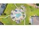 Birds eye view of the pool area, with umbrellas, seating, and mature palm trees and landscaping at 4687 Wild Iris Dr. # 303, Myrtle Beach, SC 29577