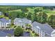 Aerial view of condo buildings surrounded by green trees and a parking lot at 5040 Windsor Green Way # 204, Myrtle Beach, SC 29579