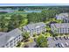 An aerial view of a condo community near a lush green golf course with multiple ponds at 5040 Windsor Green Way # 204, Myrtle Beach, SC 29579