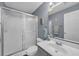 Bathroom with a large mirror and sink with a shower to the left at 5040 Windsor Green Way # 204, Myrtle Beach, SC 29579