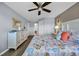 Bright bedroom with beach themed comforter, wood floors, and soft blue walls at 5040 Windsor Green Way # 204, Myrtle Beach, SC 29579