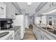 Bright kitchen featuring granite countertops, white cabinets, and stainless steel appliances at 5040 Windsor Green Way # 204, Myrtle Beach, SC 29579