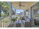 A cozy patio with a seating area overlooking a tranquil lake with a ceiling fan above at 5040 Windsor Green Way # 204, Myrtle Beach, SC 29579