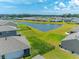 An aerial view showcasing homes surrounding a pond, with well-maintained lawns at 506 Hogwart Ln., Longs, SC 29568