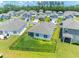 Aerial view of a well-maintained lawn and fenced backyard, surrounded by trees and residences at 506 Hogwart Ln., Longs, SC 29568