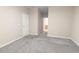Neutral bedroom with a carpeted floor, white door and an ensuite bathroom visible through the doorway at 506 Hogwart Ln., Longs, SC 29568