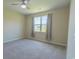 Bright bedroom with a ceiling fan and large window offering views of the outdoor landscape at 506 Hogwart Ln., Longs, SC 29568