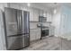 Modern kitchen with stainless steel appliances, granite countertops and grey cabinetry at 506 Hogwart Ln., Longs, SC 29568