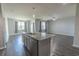Open concept kitchen with a granite island, stainless steel appliances and wood flooring at 506 Hogwart Ln., Longs, SC 29568