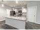 Well-equipped kitchen with a granite island, stainless steel appliances and modern lighting at 506 Hogwart Ln., Longs, SC 29568