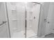 Modern glass enclosed shower with white tiled walls and brushed metal fixtures at 506 Hogwart Ln., Longs, SC 29568