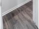 Close-up of grey wood flooring with white trim at 506 Hogwart Ln., Longs, SC 29568