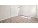 Bright bedroom featuring wood-look floors, white walls, and trim, and closet and bathroom access at 5074 Cowart Ct., Murrells Inlet, SC 29576