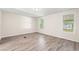 Large bedroom with plenty of natural light through the windows and wood-look flooring at 5074 Cowart Ct., Murrells Inlet, SC 29576