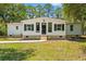 Beautiful home featuring a well-manicured lawn, mature trees, and a welcoming light exterior at 5074 Cowart Ct., Murrells Inlet, SC 29576