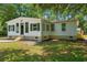 Charming home featuring light-colored exterior, black shutters, well-manicured lawn, and tree shade at 5074 Cowart Ct., Murrells Inlet, SC 29576
