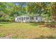 Well-maintained home with green lawn, large trees and a light-colored exterior at 5074 Cowart Ct., Murrells Inlet, SC 29576