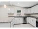 Updated kitchen features granite countertops, stainless steel appliances and sleek white cabinetry at 5074 Cowart Ct., Murrells Inlet, SC 29576