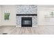 Bright living room with a stone fireplace and seamless flow into the kitchen for easy entertaining at 5074 Cowart Ct., Murrells Inlet, SC 29576