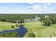 Beautiful aerial view of a golf course community with a pond and lush greenery at 556 White River Dr. # 44F, Myrtle Beach, SC 29579