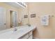 Bathroom with large mirror, white vanity, and neutral walls at 556 White River Dr. # 44F, Myrtle Beach, SC 29579