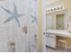 Bathroom with nautical themed shower curtain and white vanity at 556 White River Dr. # 44F, Myrtle Beach, SC 29579