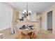 Inviting dining area features a round table, white chairs, and a view of the modern kitchen at 556 White River Dr. # 44F, Myrtle Beach, SC 29579