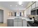 Well-lit kitchen featuring stainless steel appliances, white cabinets and view into living room at 556 White River Dr. # 44F, Myrtle Beach, SC 29579