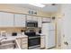 Bright kitchen features stainless appliances and white cabinets at 556 White River Dr. # 44F, Myrtle Beach, SC 29579