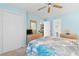 Bedroom with blue walls, ceiling fan, and large closet at 556 White River Dr. # 44F, Myrtle Beach, SC 29579